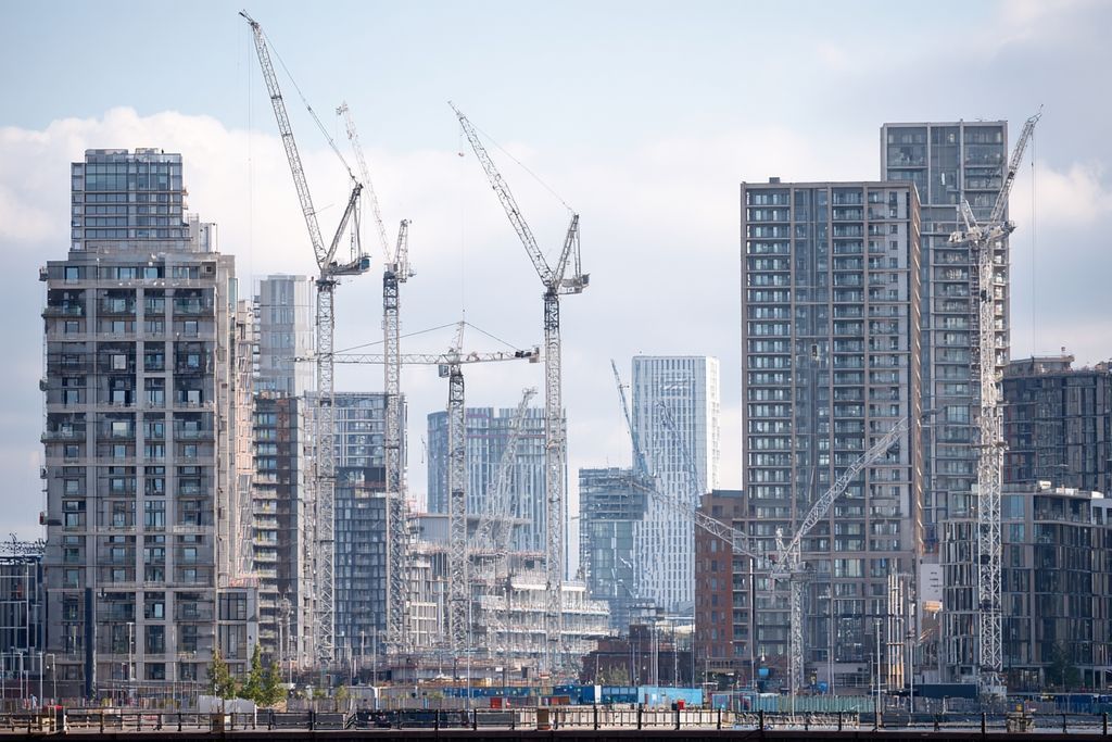 Vue d'une skyline urbaine avec des grues et échafaudages, mettant en scène l'évolution continue des projets de construction.